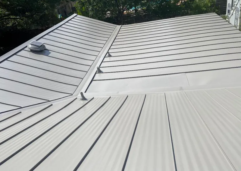 Solar attic fan installed on a metal roof for Roof Ventilation in Honeygo